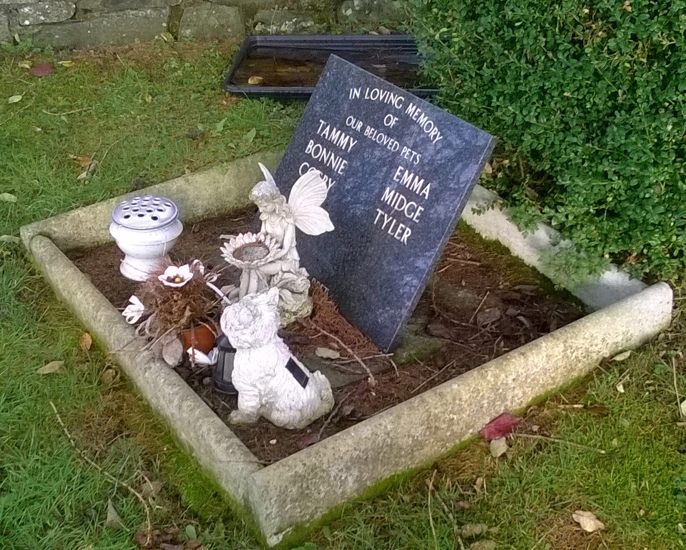 Dark gray granite supported tablet engraved with pet names