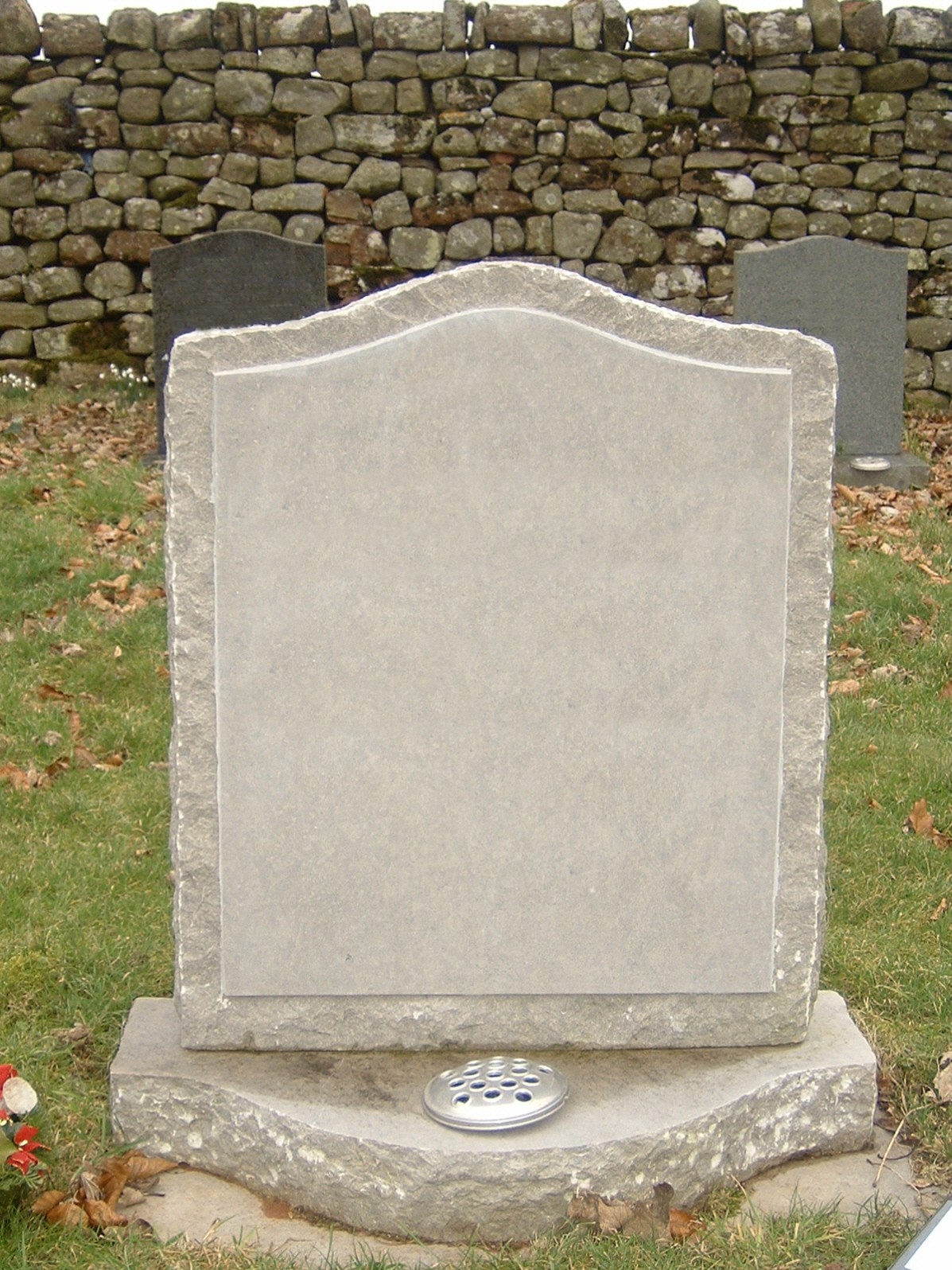 PJ19 - UK sourced Rustic limestone hand made in our workshop the shaped base compliments the curved top to the headstone.  Bespoke Headstones, Lawn Memorials