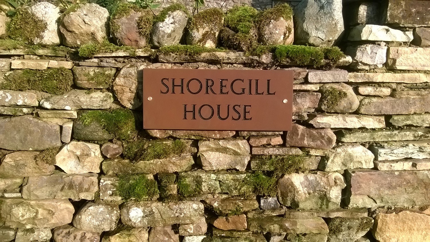Rectangular Sandstone Name Plate with 2 inch engraved letters, painted black. Designed to be attached to a wall.